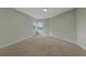 An empty bedroom with neutral walls and carpeting, with windows allowing for natural light at 3966 Villas Green, Longwood, FL 32779