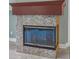 Close up of a fireplace with tile surround and wooden mantel in a neutral-toned living room at 3966 Villas Green, Longwood, FL 32779