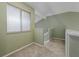 Inviting hallway with neutral carpet, green walls, natural light, and staircase access at 3966 Villas Green, Longwood, FL 32779