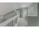 Upstairs hallway with window, neutral carpeting, and views into other rooms at 3966 Villas Green, Longwood, FL 32779