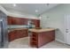 The open kitchen has updated appliances, granite countertops, and dark wood cabinets at 3966 Villas Green, Longwood, FL 32779