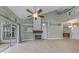 An open-concept living space with tall ceilings and a fireplace as well as access to the back patio at 3966 Villas Green, Longwood, FL 32779