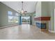Spacious living room showcasing a fireplace, tile flooring, and natural light from large windows at 3966 Villas Green, Longwood, FL 32779