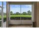 Enclosed patio offers stunning views of the lush green golf course and blue sky at 3966 Villas Green, Longwood, FL 32779