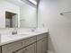 Modern bathroom featuring double sinks, gray cabinets, and a large mirror at 3975 Silverstream Ter, Sanford, FL 32771
