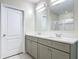 Bathroom featuring double vanity with quartz countertop and gray cabinets with a walk-in shower in the background at 3975 Silverstream Ter, Sanford, FL 32771