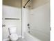 Bathroom with a white tiled shower and bathtub combo, and a white toilet at 3975 Silverstream Ter, Sanford, FL 32771