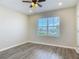 This bedroom features recessed lighting, gray floors, and a view to the outdoors at 3975 Silverstream Ter, Sanford, FL 32771