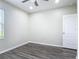This bedroom features gray floors, a ceiling fan, and a bright window at 3975 Silverstream Ter, Sanford, FL 32771