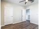 Cozy bedroom featuring wood-look floors, a ceiling fan, and neutral walls with a closed door at 3975 Silverstream Ter, Sanford, FL 32771