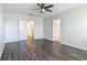 Spacious bedroom showcasing wood-look floors and neutral walls with two doors at 3975 Silverstream Ter, Sanford, FL 32771