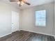 This bedroom features a ceiling fan, window, and a classic white door at 3975 Silverstream Ter, Sanford, FL 32771