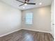 Bedroom with wood floors, ceiling fan, and a window provides ample light at 3975 Silverstream Ter, Sanford, FL 32771