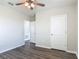 This bedroom has gray wood-look floors and a hallway leading to another room at 3975 Silverstream Ter, Sanford, FL 32771