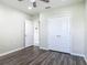 Bedroom with gray wood-look floors, a closet, and a view into the hall at 3975 Silverstream Ter, Sanford, FL 32771