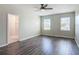Bedroom with hardwood floors, two windows bringing in natural light, and neutral paint at 3975 Silverstream Ter, Sanford, FL 32771
