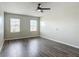 Bedroom featuring hardwood floors, two windows and neutral-colored walls at 3975 Silverstream Ter, Sanford, FL 32771