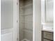 Linen closet next to a gray vanity with white quartz countertop and wire shelving for storage at 3975 Silverstream Ter, Sanford, FL 32771
