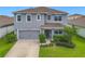 Charming two-story home featuring a gray exterior, well-maintained landscaping, and attached two-car garage at 3975 Silverstream Ter, Sanford, FL 32771