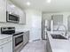 Kitchen with stainless steel appliances and gray cabinetry at 3975 Silverstream Ter, Sanford, FL 32771