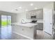 Open kitchen featuring a center island with white countertops and gray cabinets, flowing into the breakfast area at 3975 Silverstream Ter, Sanford, FL 32771