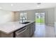 Kitchen island sink with stainless steel dishwasher and backyard view at 3975 Silverstream Ter, Sanford, FL 32771