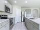 Bright kitchen featuring stainless steel appliances and quartz countertops at 3975 Silverstream Ter, Sanford, FL 32771