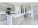 Open kitchen featuring a large center island, stainless steel appliances, and seamless flow to other living spaces at 3975 Silverstream Ter, Sanford, FL 32771