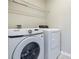 Laundry room features a white washer and dryer, and wire shelving at 3975 Silverstream Ter, Sanford, FL 32771