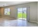 Open living room with neutral tile flooring and large sliding glass doors, providing a view of the backyard at 3975 Silverstream Ter, Sanford, FL 32771