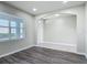 Bright living room with an archway and wood-look flooring at the entry at 3975 Silverstream Ter, Sanford, FL 32771