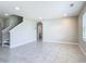 Spacious living room featuring neutral tile, stairs to the second floor, and a view into the connecting bathroom at 3975 Silverstream Ter, Sanford, FL 32771