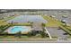 Aerial view of the community pool with seating, clubhouse, and landscaping at 3975 Silverstream Ter, Sanford, FL 32771