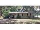 Charming single-story home with a covered parking area and well-maintained landscaping in a beautiful shady setting at 401 Sunny Ct, Fruitland Park, FL 34731