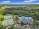 This aerial view showcases community amenities including tennis courts, pool, and clubhouse, with a backdrop of lush greenery at 4334 Tolkien St, Orlando, FL 32828