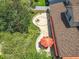 Aerial view of a landscaped backyard with a patio, fire pit, seating area, and lush greenery at 4334 Tolkien St, Orlando, FL 32828