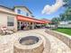 Spacious backyard with a fire pit, patio, outdoor kitchen, and green lawn at 4334 Tolkien St, Orlando, FL 32828