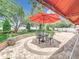 Cozy backyard featuring outdoor dining under a shade umbrella and colorful landscaped space at 4334 Tolkien St, Orlando, FL 32828