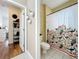 Well lit bathroom leading to a second space featuring a toilet and beautifully patterned shower curtain at 4334 Tolkien St, Orlando, FL 32828