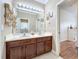 Bathroom featuring double sinks, a large mirror, and access to an adjacent shower room at 4334 Tolkien St, Orlando, FL 32828