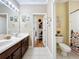 Bathroom featuring double sinks, a large mirror and access to a second space featuring a toilet and shower at 4334 Tolkien St, Orlando, FL 32828
