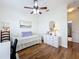 Well-lit bedroom featuring hardwood floors, a daybed, and a white dresser for ample storage at 4334 Tolkien St, Orlando, FL 32828