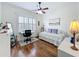 Bright bedroom with a large window, hardwood floors, a desk, and a cozy daybed at 4334 Tolkien St, Orlando, FL 32828