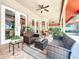 Relaxing covered patio with wicker furniture, ceiling fan, and beautiful tiled flooring at 4334 Tolkien St, Orlando, FL 32828