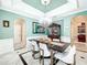 Stylish dining room with a modern table, chandelier, and plenty of natural light at 4334 Tolkien St, Orlando, FL 32828