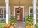 Inviting front door with decorative wreath, stone tile floor, and manicured landscaping at 4334 Tolkien St, Orlando, FL 32828