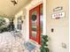 Close-up of a front door entrance with brick flooring, a vibrant door, and elegant design at 4334 Tolkien St, Orlando, FL 32828
