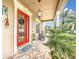 Welcoming front entrance with a bright red door, stylish decor, and a charming covered porch at 4334 Tolkien St, Orlando, FL 32828