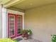Inviting front entrance with vibrant red double doors and decorative potted plants at 4334 Tolkien St, Orlando, FL 32828