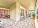 Spacious front porch with tile flooring, seating, and a view of the landscaped front yard at 4334 Tolkien St, Orlando, FL 32828